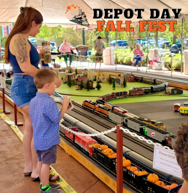 picture of mom and son watching model trains at the Depot Day Fall Fest