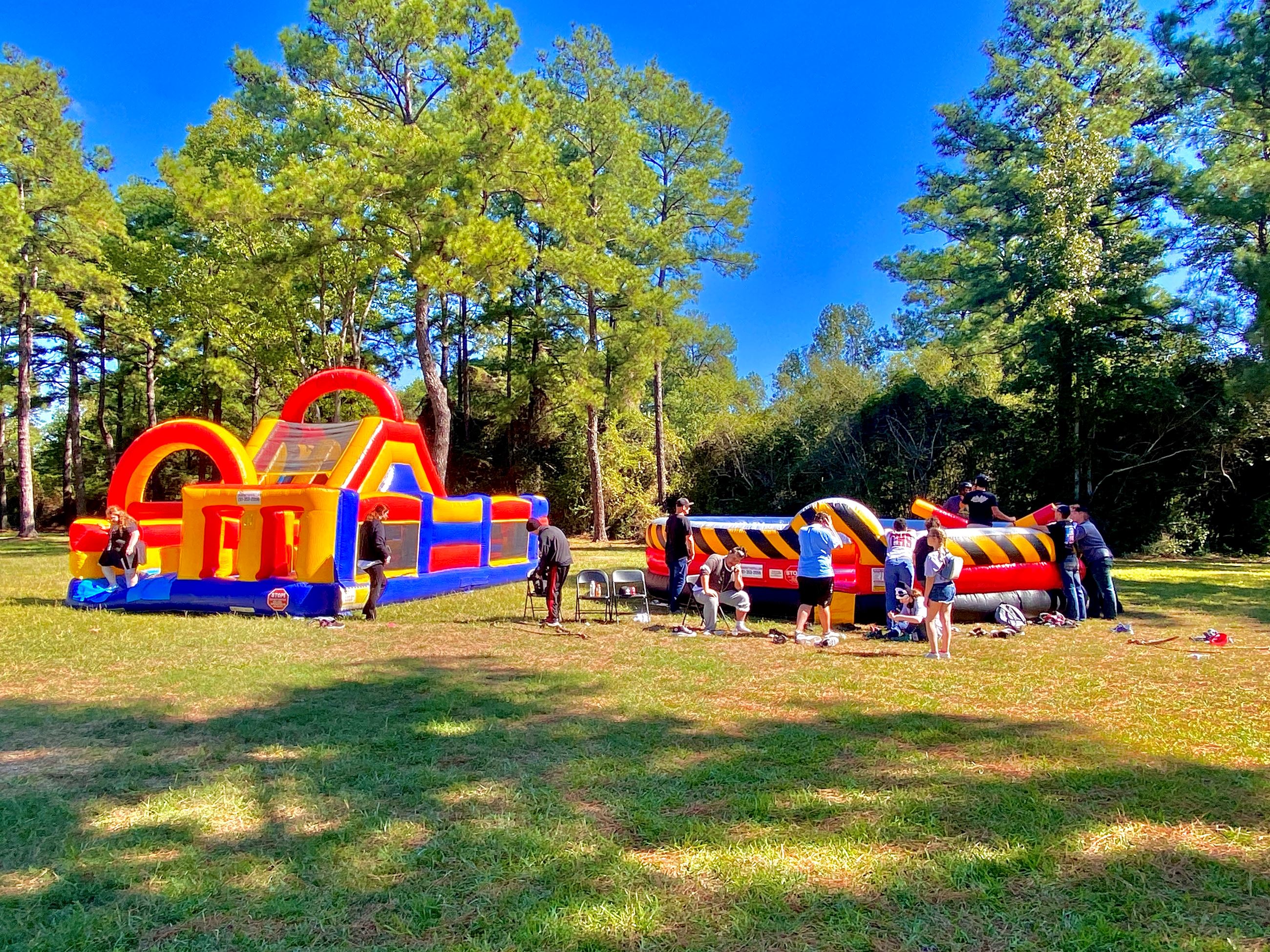 picture of THS students playing in a couple of bouncehouses