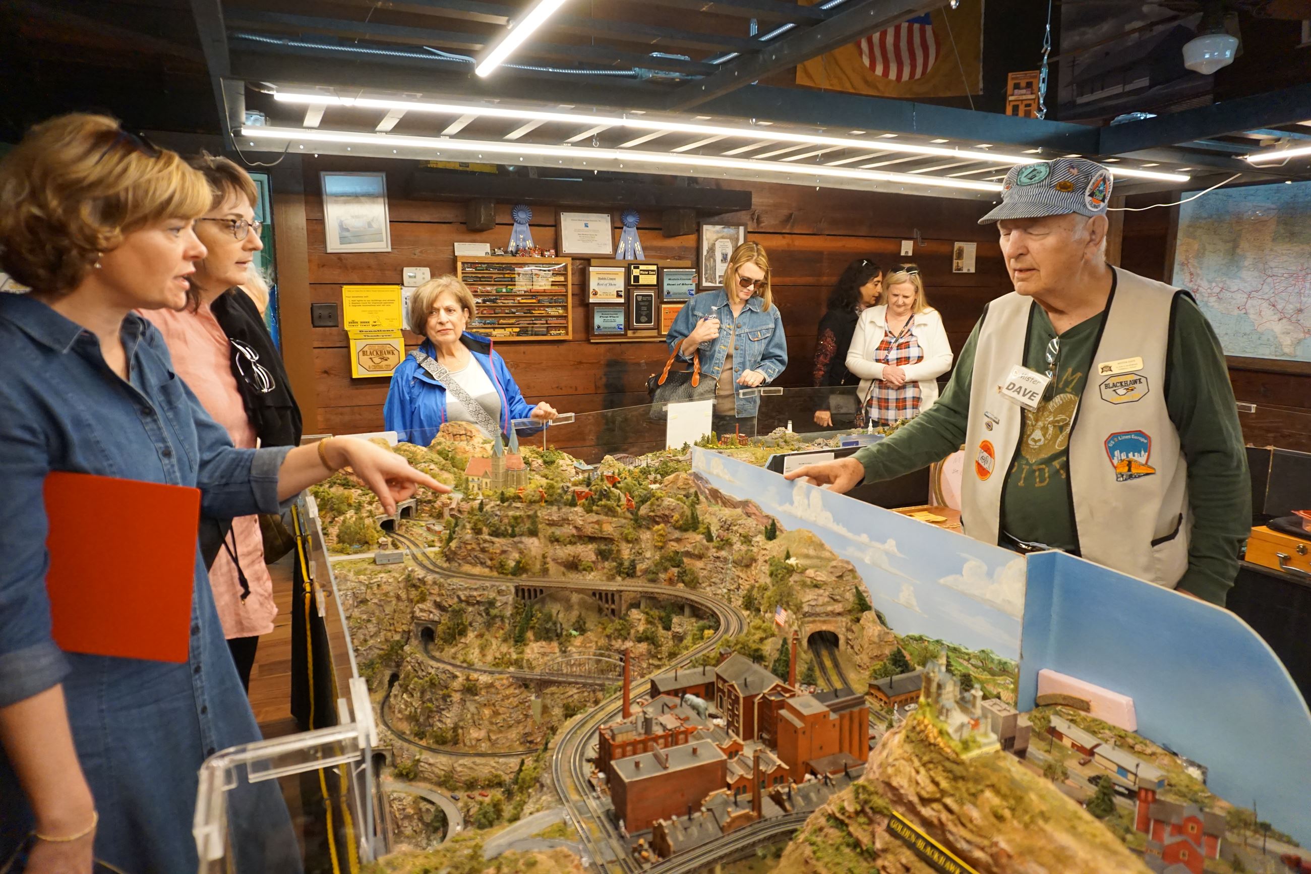 Group of ladies enjoy learning about the Z-scale model railroad inside the Depot