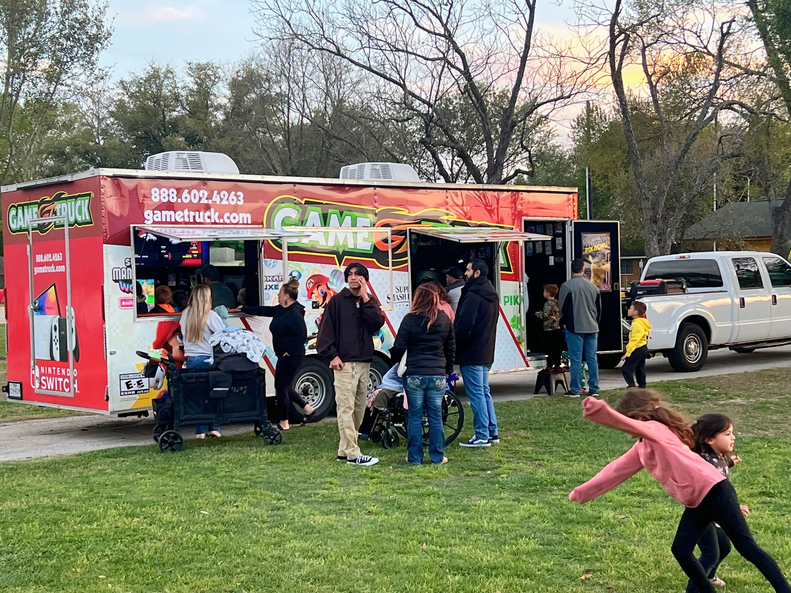 kids playing various Mario games inside the game truck