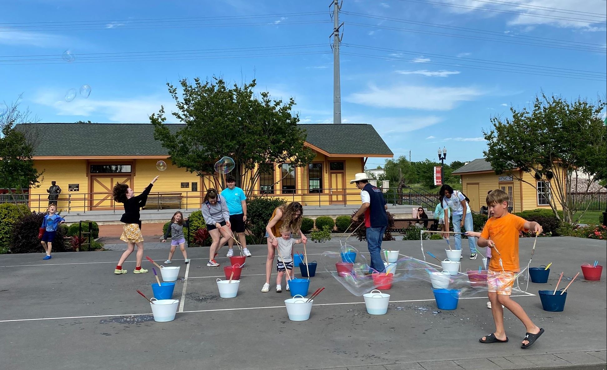 Kids making bubbles at 2nd Saturday