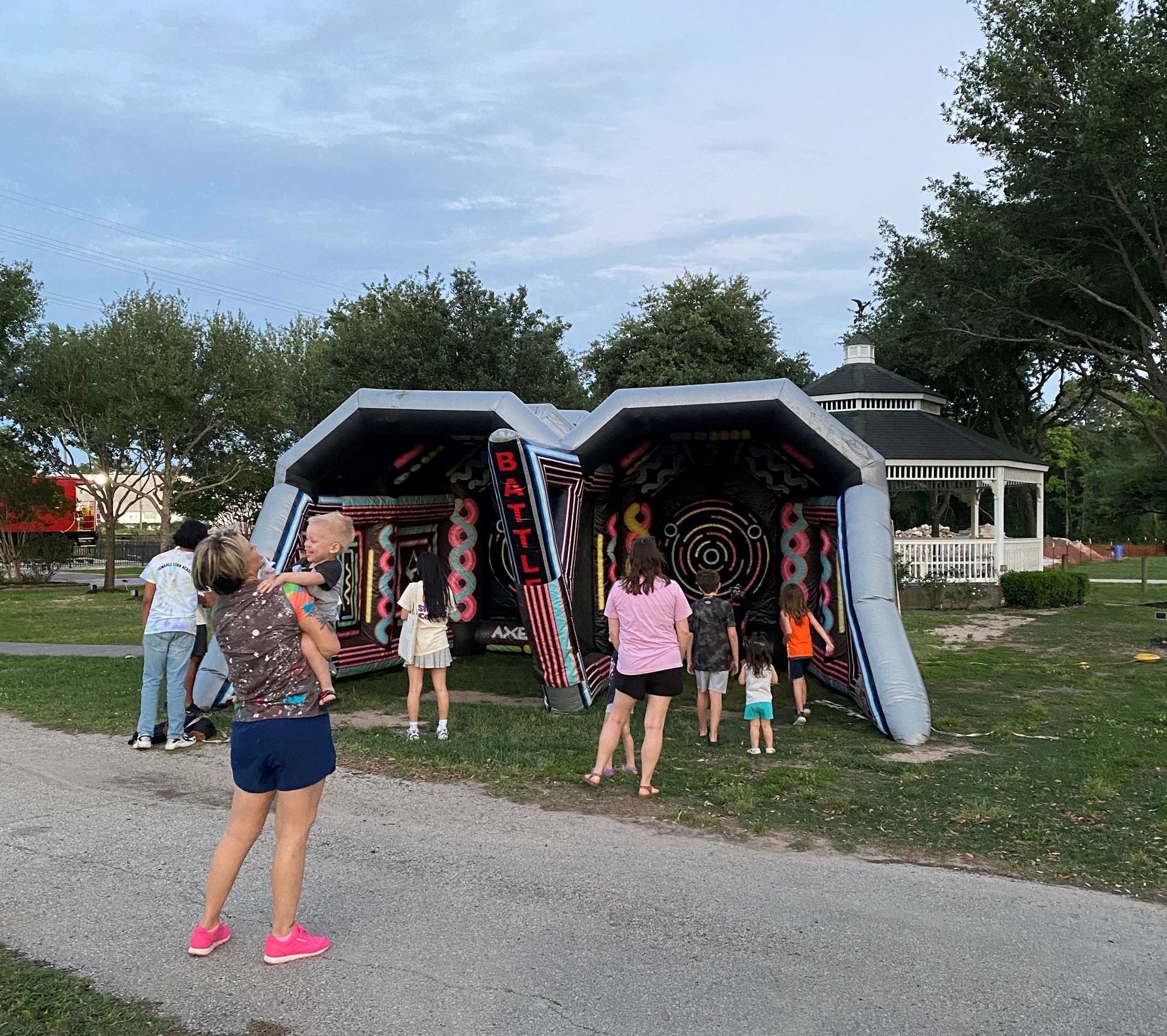 Kids participating in glow in the Dark Axe throwing