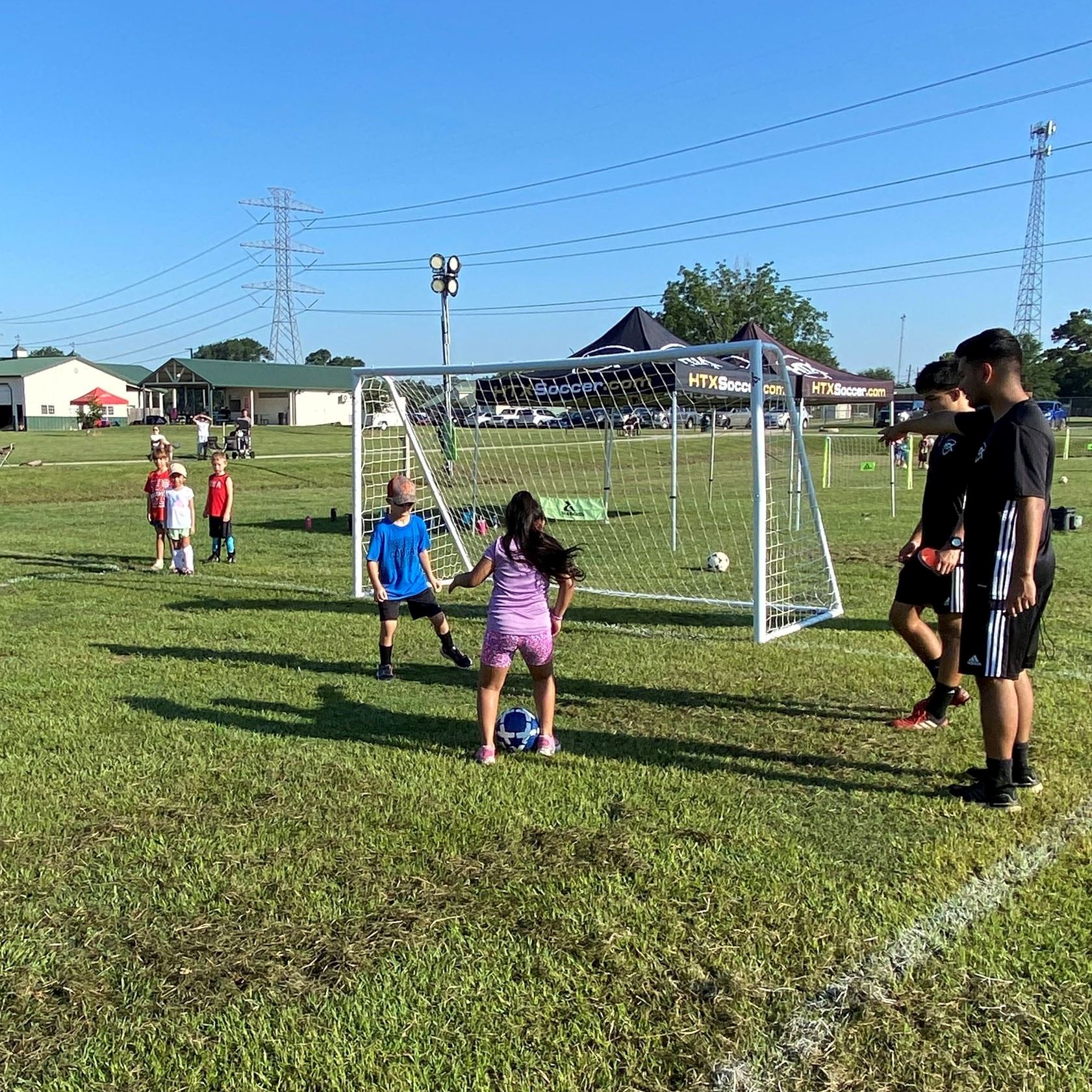 picture of campers learning how to strike a soccer ball into the net